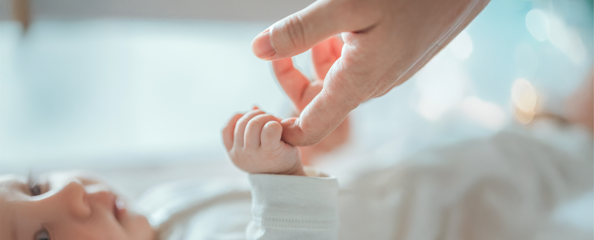 Baby holding Mother's Index Finger
